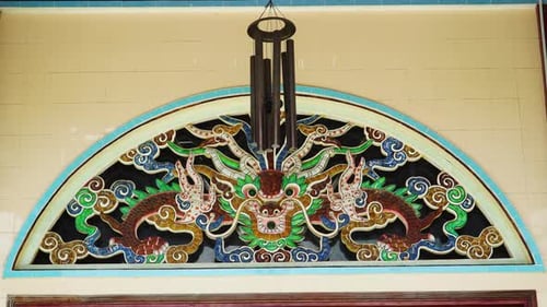 Windchime hanging in front of Buddhist temple decoration. Static view
