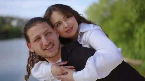 Couple Enjoying Piggyback Ride in Park
