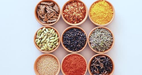 Spices, herbs and bowls for advertising, table and studio for curry, condiments and seasoning