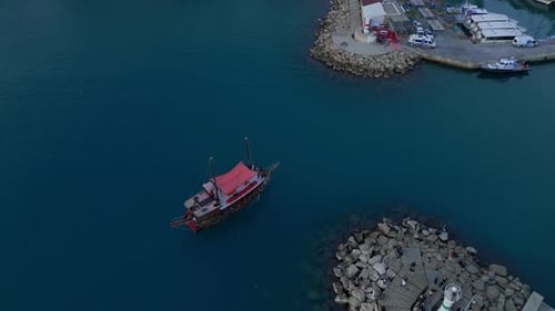 A Tourist Small Ship Returns to the Antalya Seaport in the Old Town