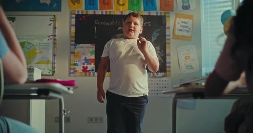 STEM Class Shy Elementary School Boy Presenting Homework on Ecology in Front of Classmates