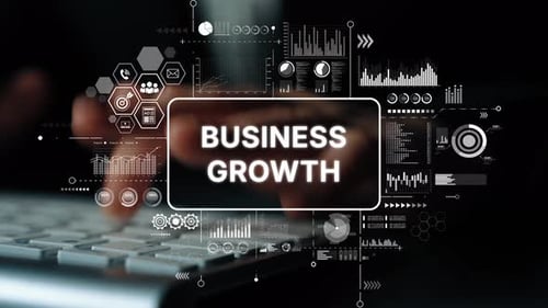 Typing on Keyboard with Business Growth Graphics Overlay