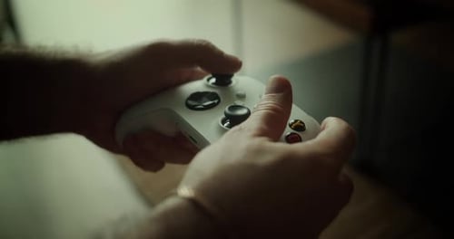 Man Gamer Hands Holding Modern Console for Play Station Closeup Guy Playing Video Games