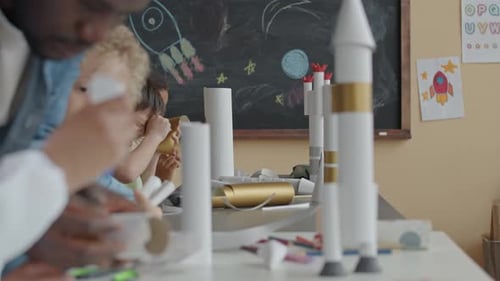 Children and Teacher Making Paper Rockets on School Lesson