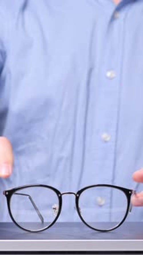 Vertical Video Businessman Placing Eyeglasses on Laptop After Finishing Work
