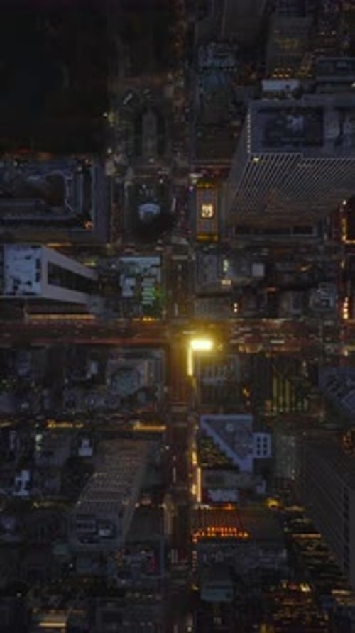 Vertical Video Reveals Manhattan New York City Rooftops in Slow Motion at Night Streets are Bustling