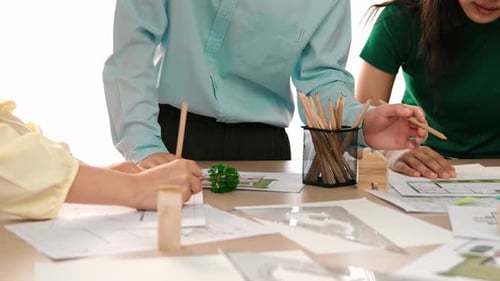 Architect using divider to measure blueprint. Focus on hand. Delineation.