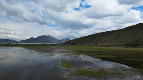 Aerial view over lake with mountains in the background