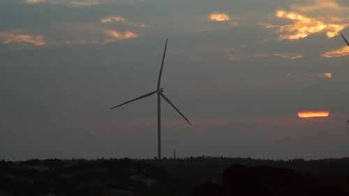 Wind Turbines Spinning at Beautiful Sunrise or Sunset