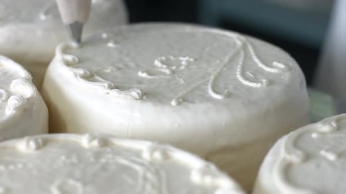 Decorating Small Cake with Elegant White Frosting