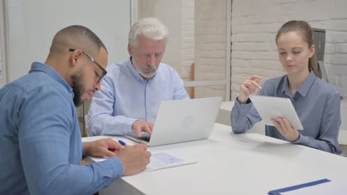 Mixed Race People Working in Office