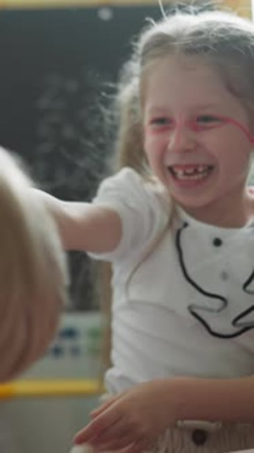 Couple of Cheerful Children Laughs and Makes Funny Faces