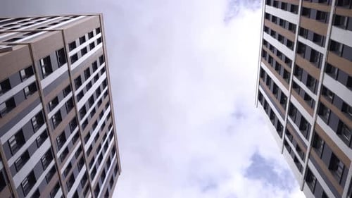High Rise Buildings with Panels on Facades Under Cloudy Sky