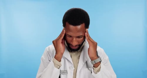 Frustrated, black man and doctor with headache in studio for stress, pain