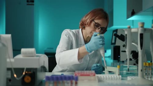 Woman Scientist Working in a Blue Laboratory