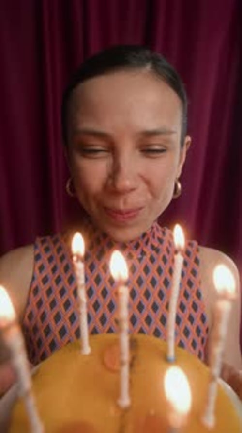 Woman Blowing Out Birthday Candles in Vertical Video