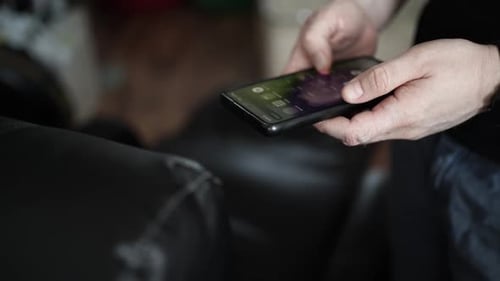 Adult Person Using Smartphone Indoors