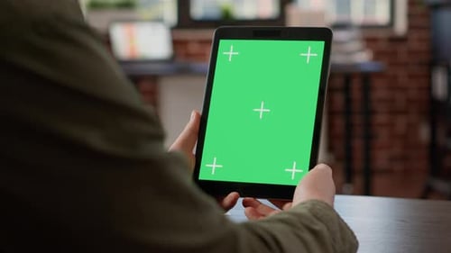 Tablet with Green Screen in Modern Office