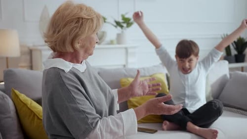 Grandmother and Grandson spending time together in living room