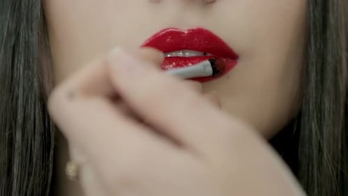 Woman Applies Red Lipstick with Brush, Close Up