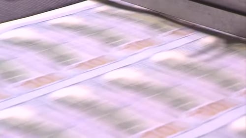SHEETS OF 100 DOLLAR BILLS AT THE PRINTING PRESS
