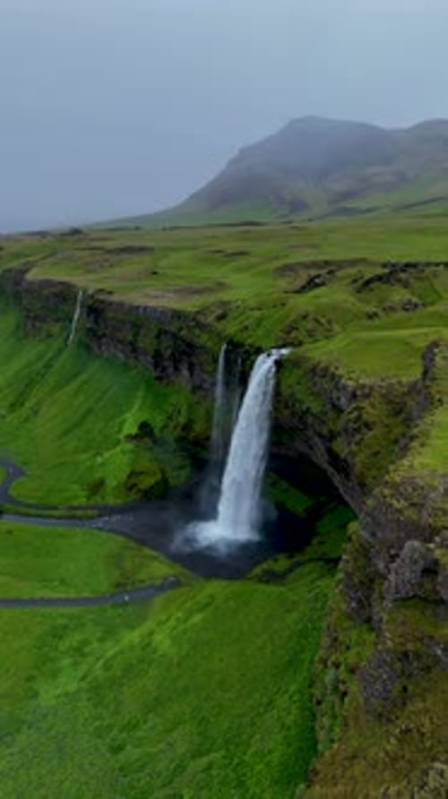 Majestic Seljalandsfoss Waterfall Cascading Down Lush Green Cliffs in Icelands Stunning Landscape