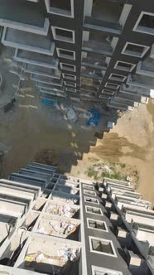 Vertical Video Aerial Gaze Construction Site of a Multistory Building Unfolding Below