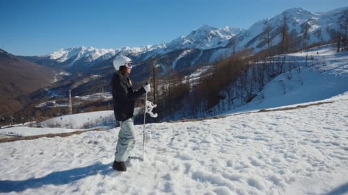 Woman Snowboarder on Snowy Mountain on a Sunny Day