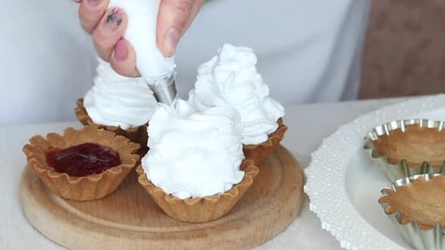 A Woman Makes A Cake Basket. Applying Cream From A Pastry Bag. For Baked Cakes. Close Up
