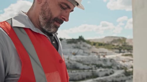 Bearded Mature Foreman Using Digital Tablet