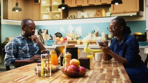 Couple Relaxing Together in Bright Modern Kitchen