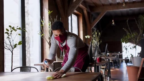 Waiter Disinfecting and Dancing in Restaurant