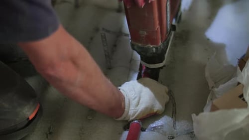 Construction Worker Installing Piping with a Jackhammer
