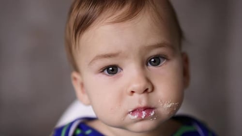 Charming Baby Close Up with Food on Face