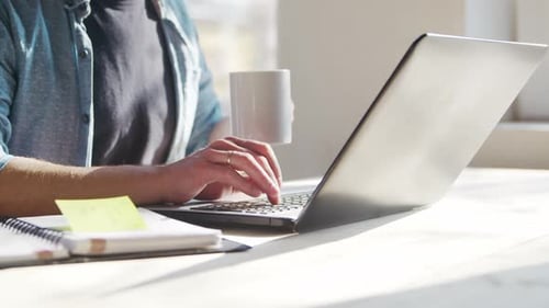 Young Male Entrepreneur Works at Home Office at the Computer Workplace of Freelancer or Student