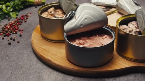 Assorted Canned Seafood Selection on Wooden Board