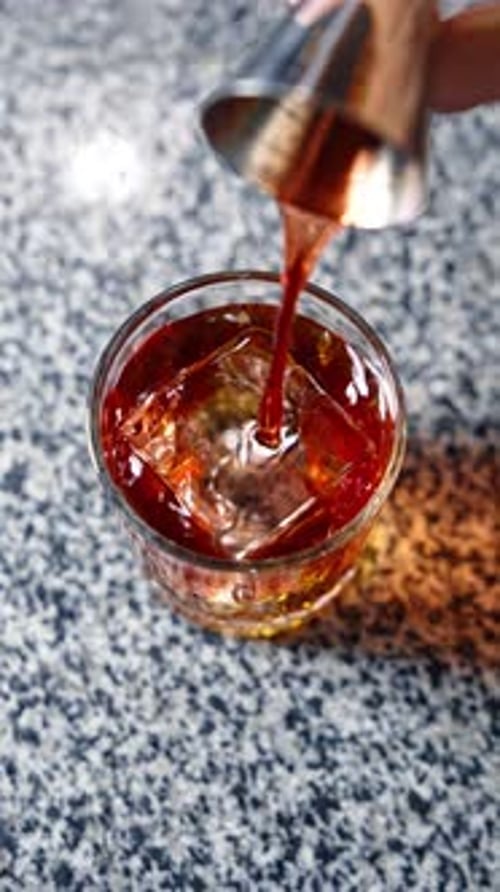 Liquor Poured Over Ice in Clear Glass