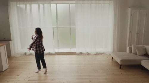 Woman Dancing in a Bright Living Room