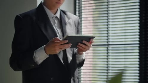 Closeup Shot of Business Woman in Suit Using Tablet in Office Building Architector Working on