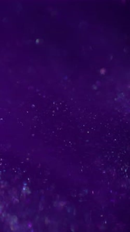 Iridescent Glitter Sparkles on a Dark Purple Background