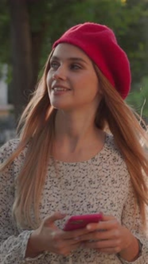 Stylish Woman with Phone in Urban Park