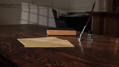 Lawyer's table in historic courtroom with quill pen, parchment, legal book 1800s