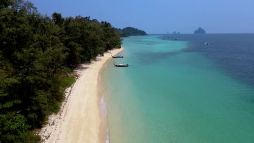 Picturesque Tropical Beach with Boats and Turquoise Water