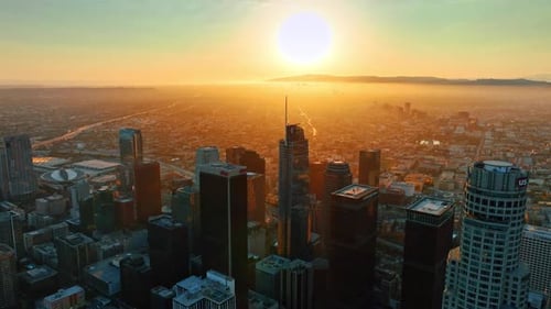 Flight over the high-rise downtown of Los Angeles, California, USA at sunset.