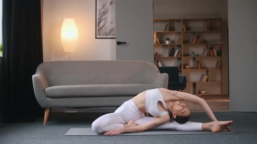 Young Woman Stretches During Yoga Workout