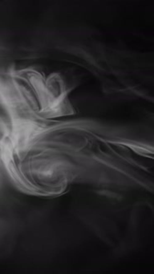 White Smoke Swirling on Black Background