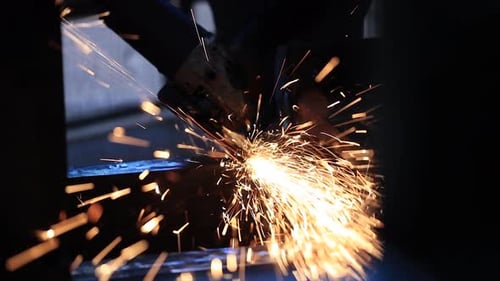 A man works circular saw, Flies of spark from hot metal, The man's hard work, Man Chlef and smooth s