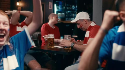 Diverse Fans React to Sporting Event in Bar