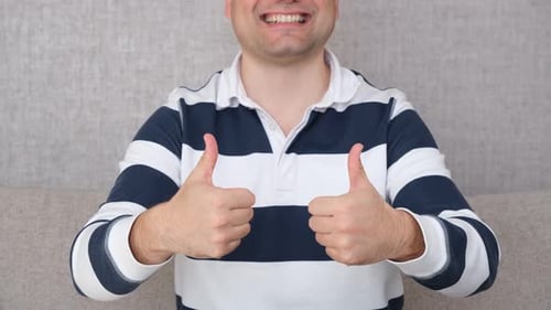 Man Gives Two Thumbs Up Indoors