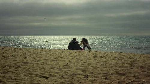 Family capturing beautiful sunset memories on a sunny beach vacation trip